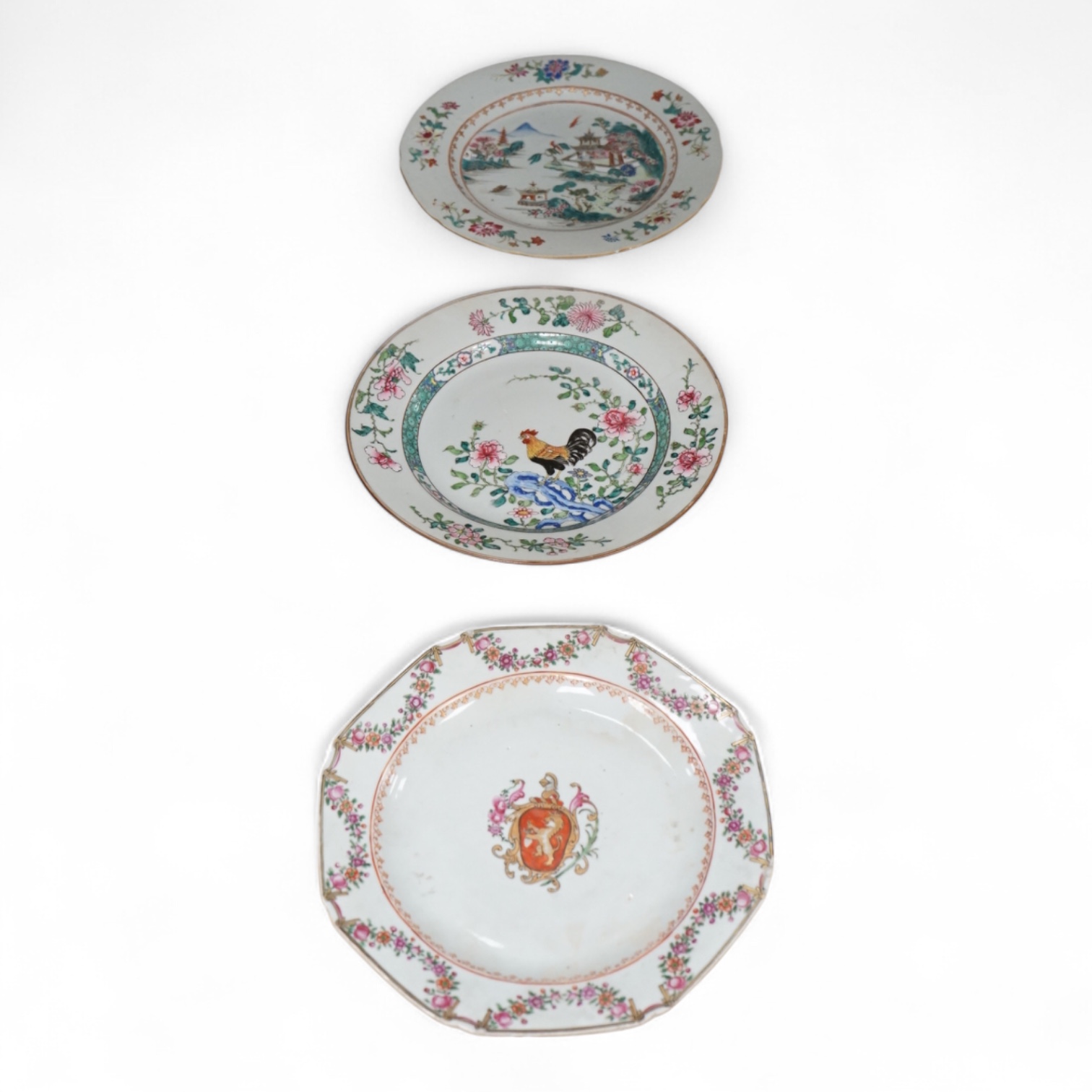 Three Chinese famille rose plates, Qianlong, including an armorial example, largest 22.5cm in diameter
